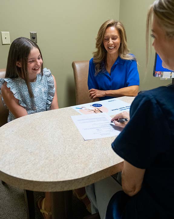 Mom and daughter having a consultation with a insurance specialist