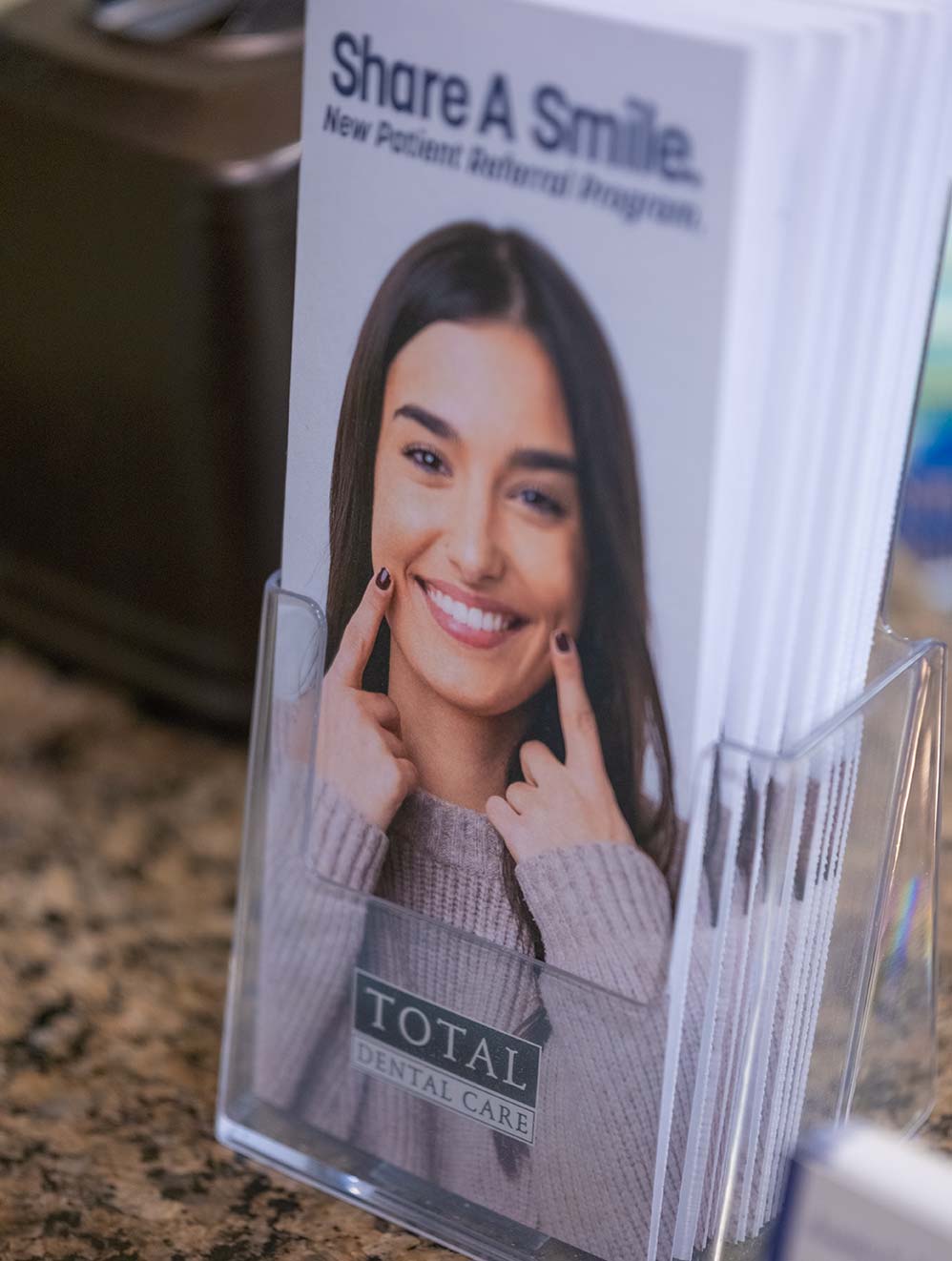 rack of Share A Smile brochures sitting on the front desk counter
