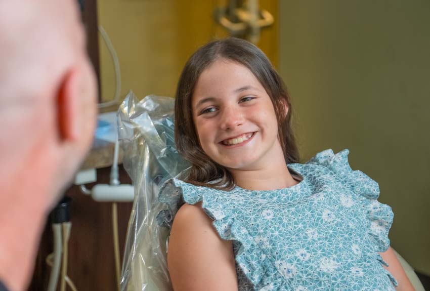 happy pediatric dental patient with Dr. Harper having a consultation