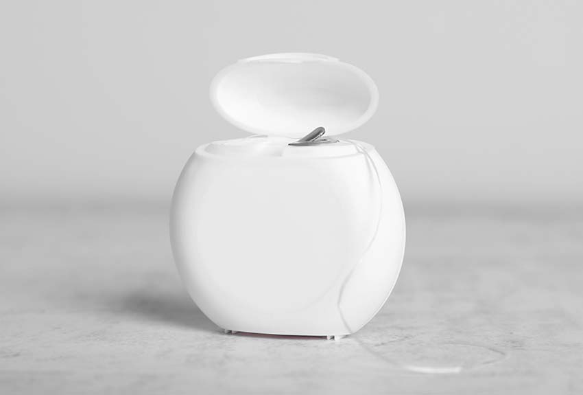 close-up of a container of dental floss sitting on a counter