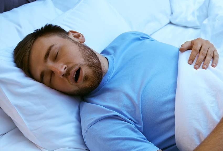 middle aged man with a beard asleep and snoring