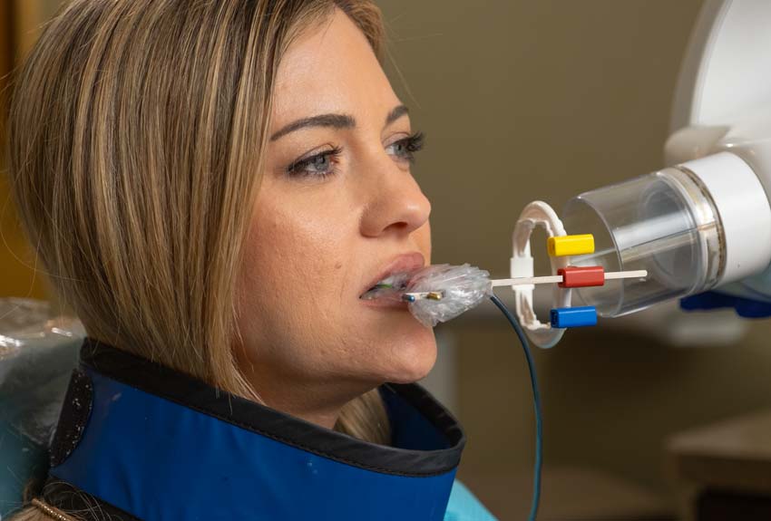 female patient in dental chair getting an x-ray